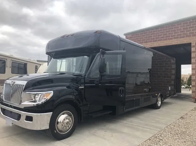 Black-painted 28 Passenger Party Bus ready for booking