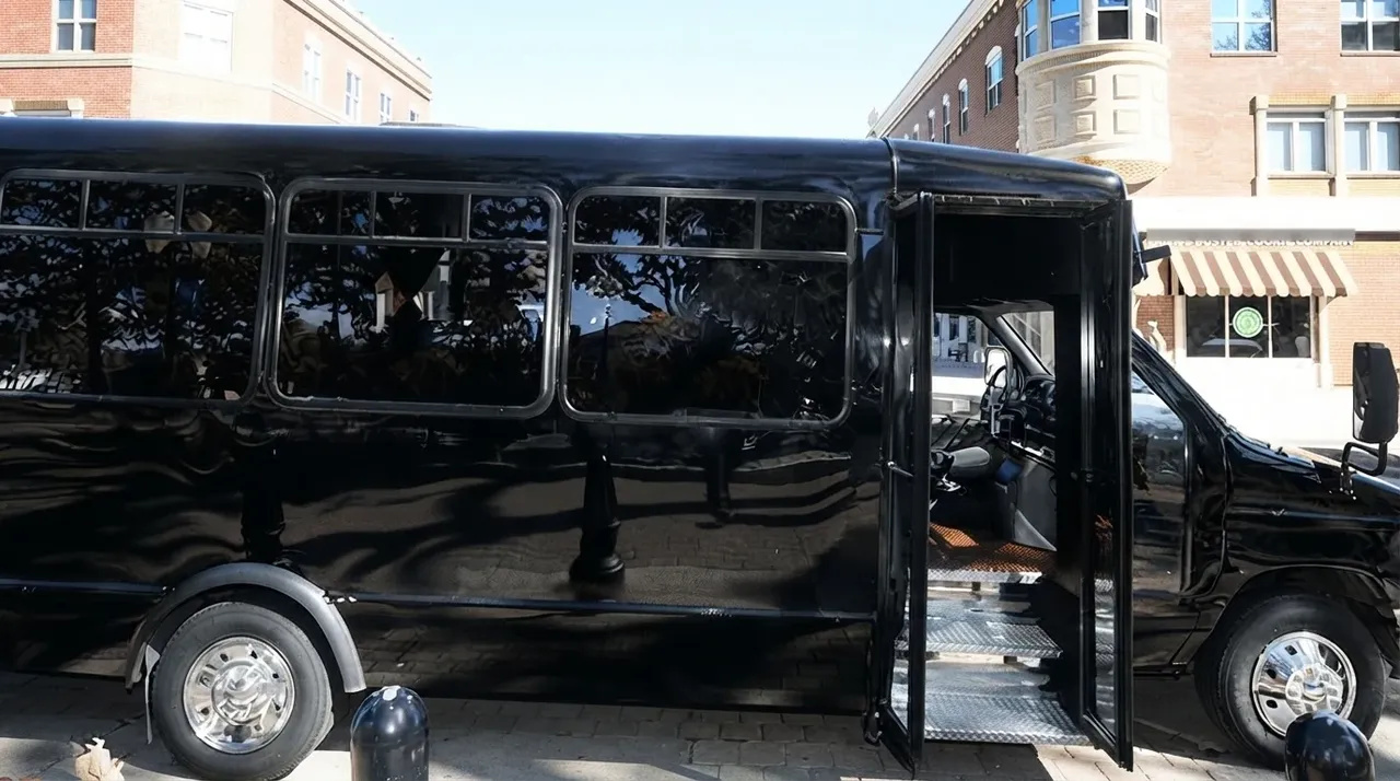 Black-painted 18 Passenger Party Bus ready for booking