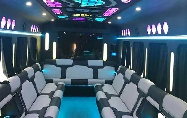 Party Bus White Party Bus White, inside view, perimeter lounge seating, window shades and LED accent lighting