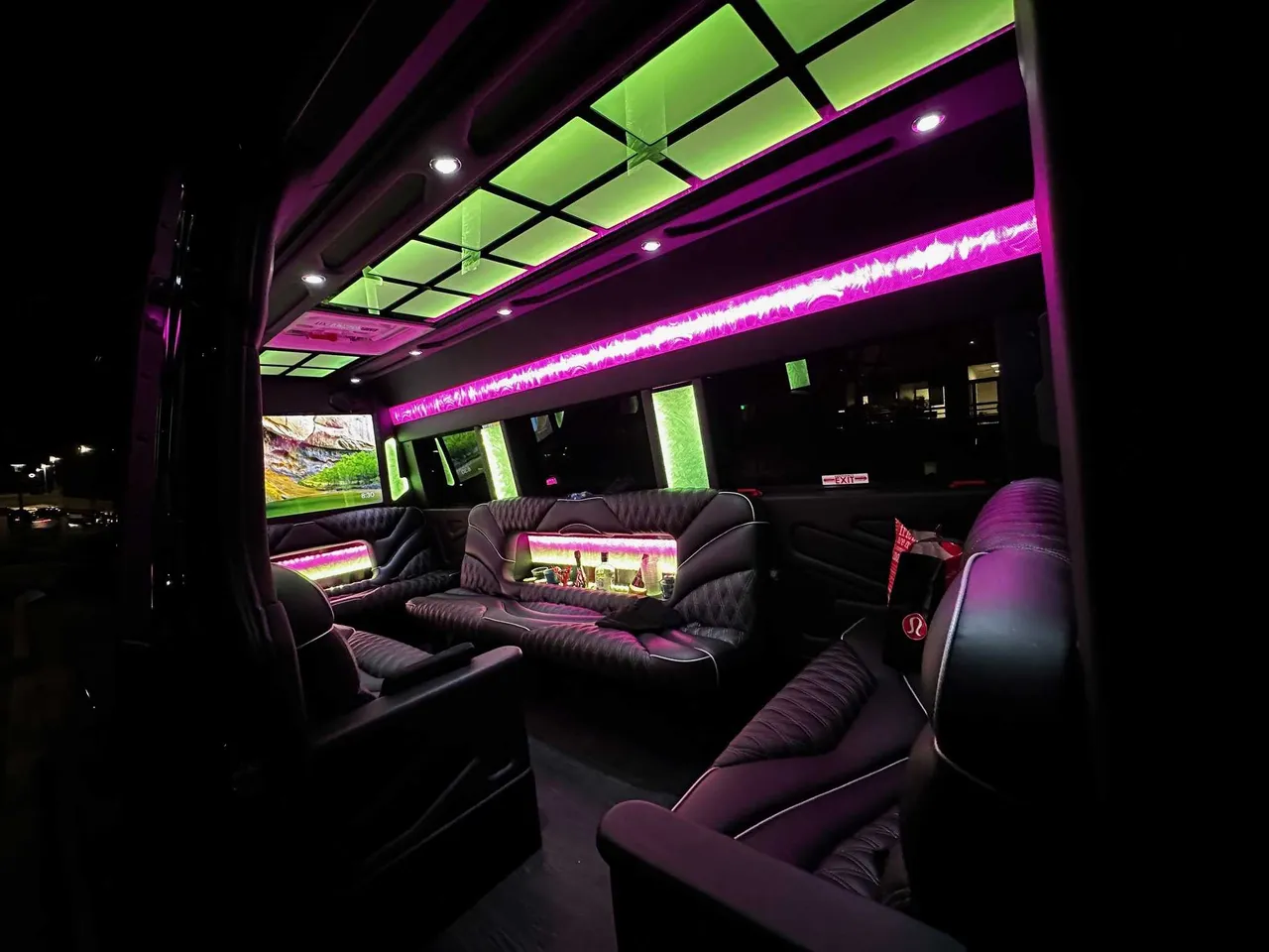 13 Passenger Sprinter Limo 13 Passenger Sprinter Limo interior with sofa-style seating, captain's chairs and LED accent lighting for party bus rental