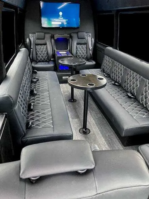 12 Passenger Mercedes-Benz Party Bus, inside view, captain's chairs, passenger tables and TV screens